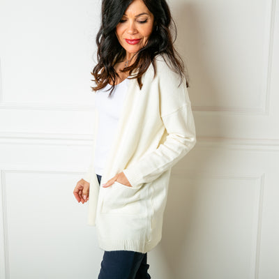The Essentials Knit Cardigan in cream white with an open front and pockets on either side