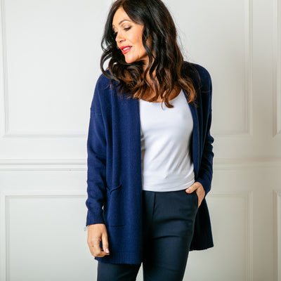 The Essentials Knit Cardigan in navy blue with an open front and pockets on either side