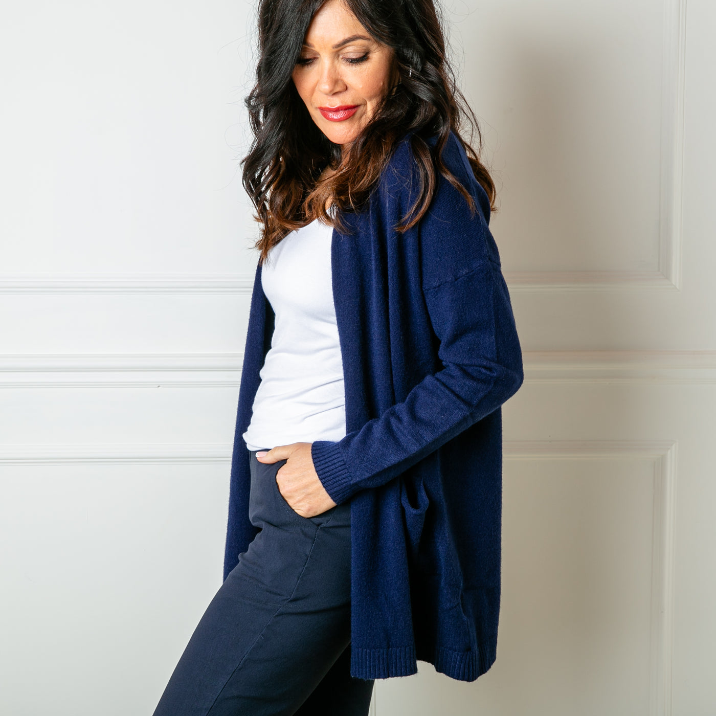 The navy blue Essentials Knit Cardigan with ribbed detailing around the sleeve cuffs and bottom hemline