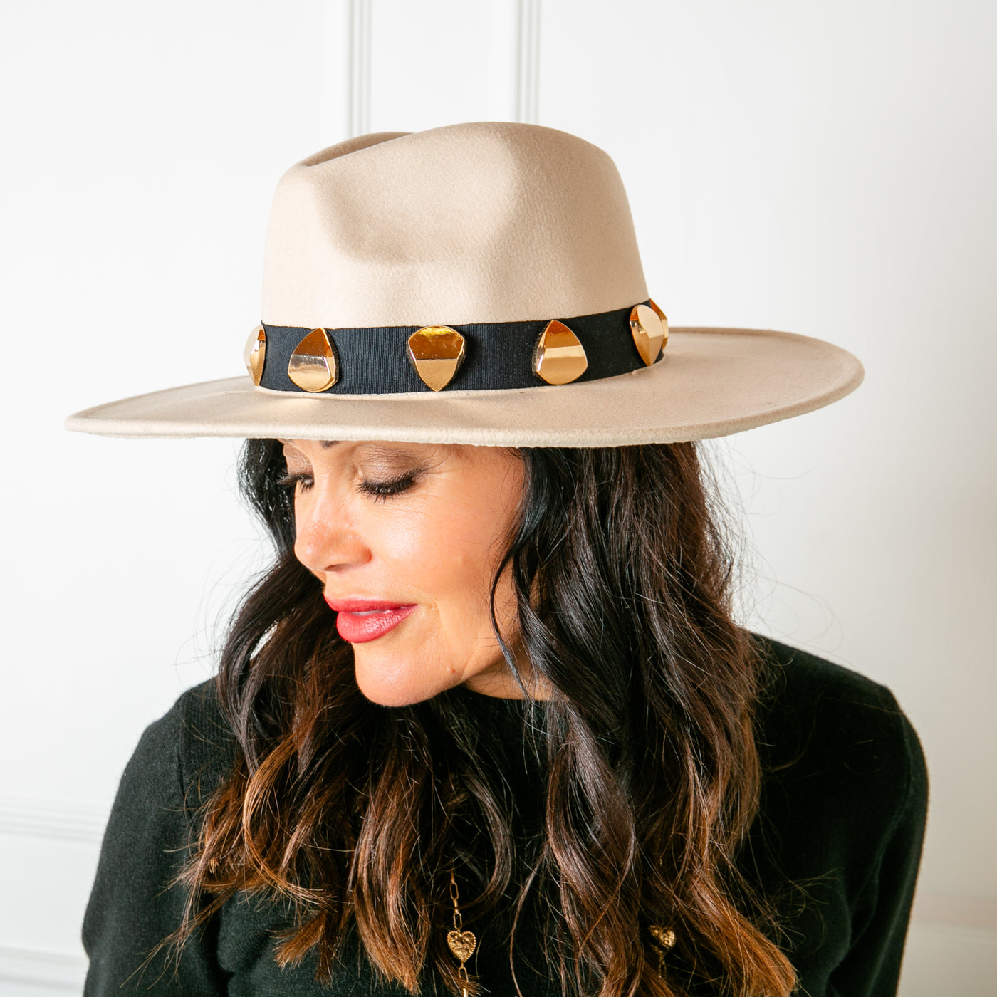 The beige Fedora Hat, made from a felted material for a structured look, perfect for making a statement