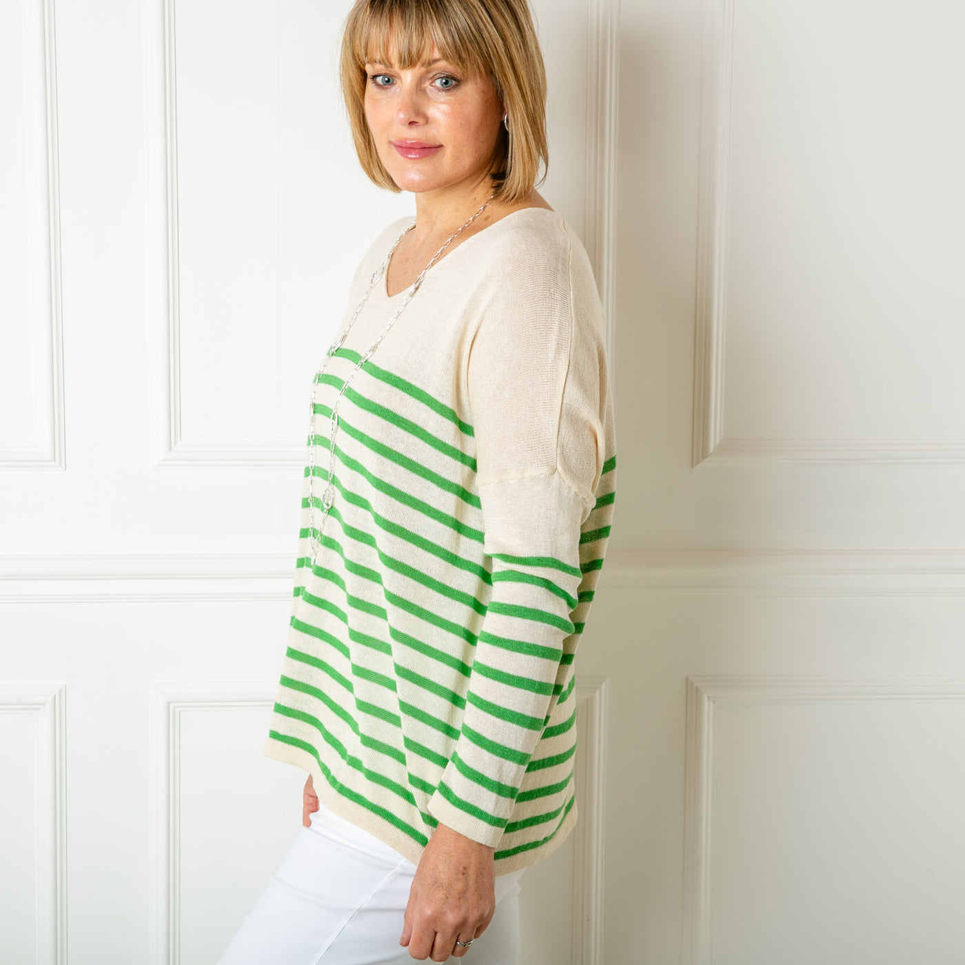The Fine Knit Stripe Jumper in cream with emerald green stripes across the sleeves and body