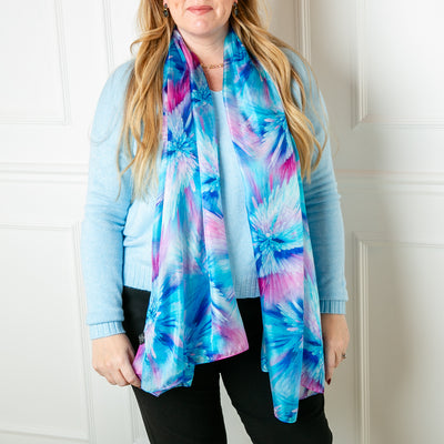 The floral fade Silk Scarf featuring a delicate print with shades of pink purple and blue