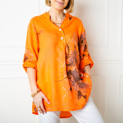 The orange floral Linen Top featuring a beautiful flower design across one side of the bodice and the sleeves