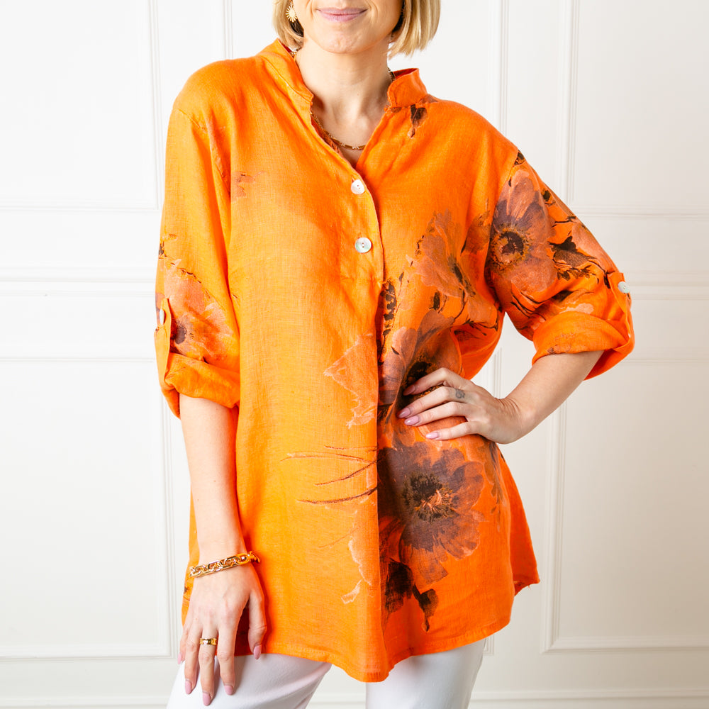 The orange Floral Linen Top with 3/4 length sleeves that can be buttoned and fastened at the elbow
