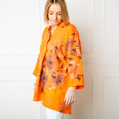 The orange Floral Linen Top with a collarless v neckline and button fastening down the front
