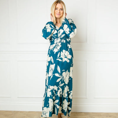 The teal blue Floral Print Maxi Dress featuring a colourful flower pattern perfect for brightening up a winter wardrobe