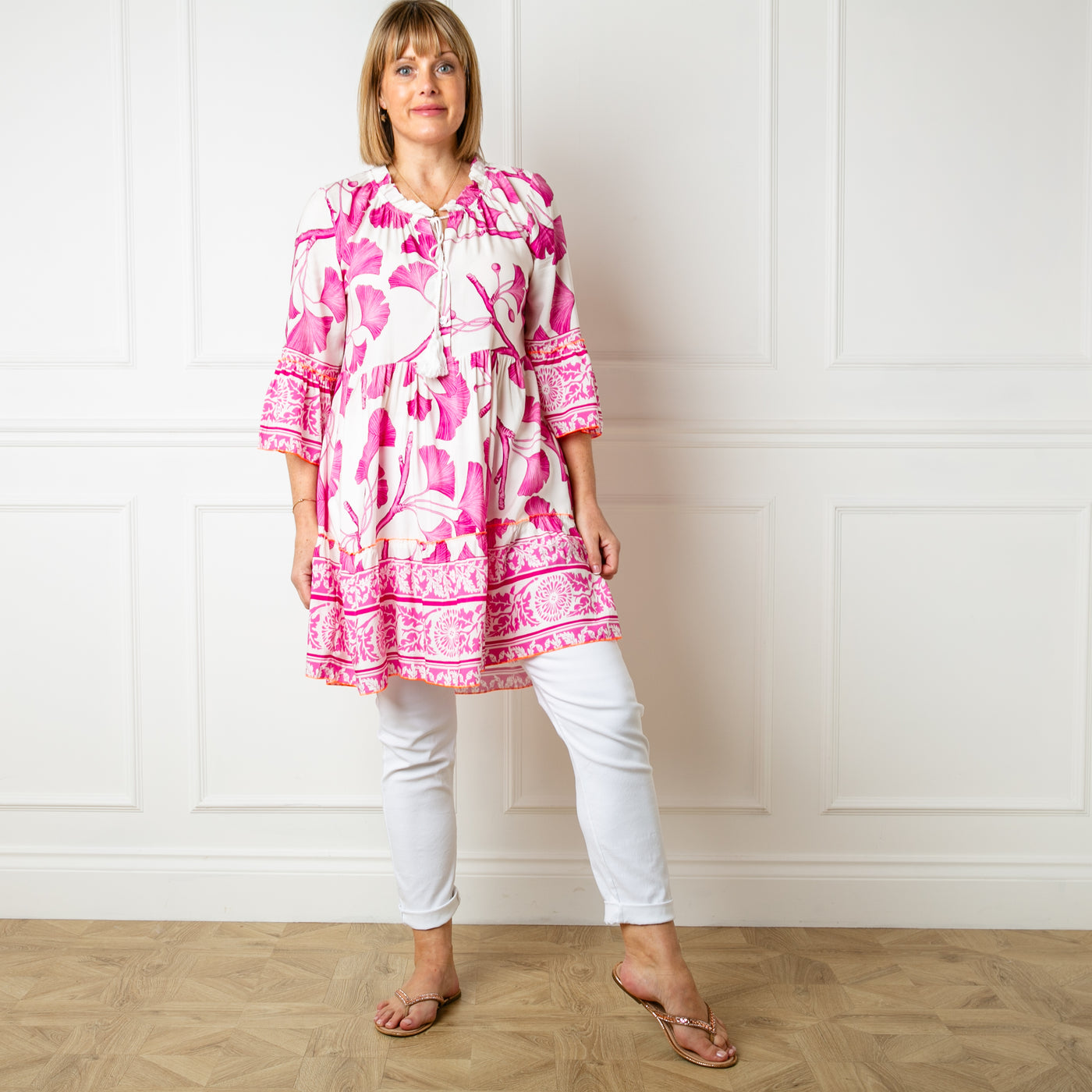 The pink Florence Drawstring Dress which has a tiered skirt and falls just above the knee. Can be worn on its own or with trousers underneath for a tunic look