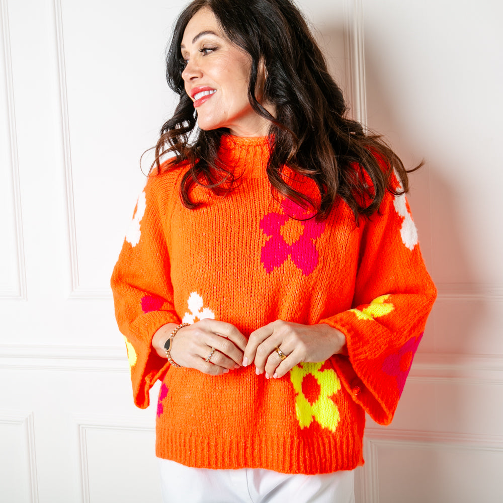 The Flower Power Jumper in orange with wide long sleeves and a high neckline 