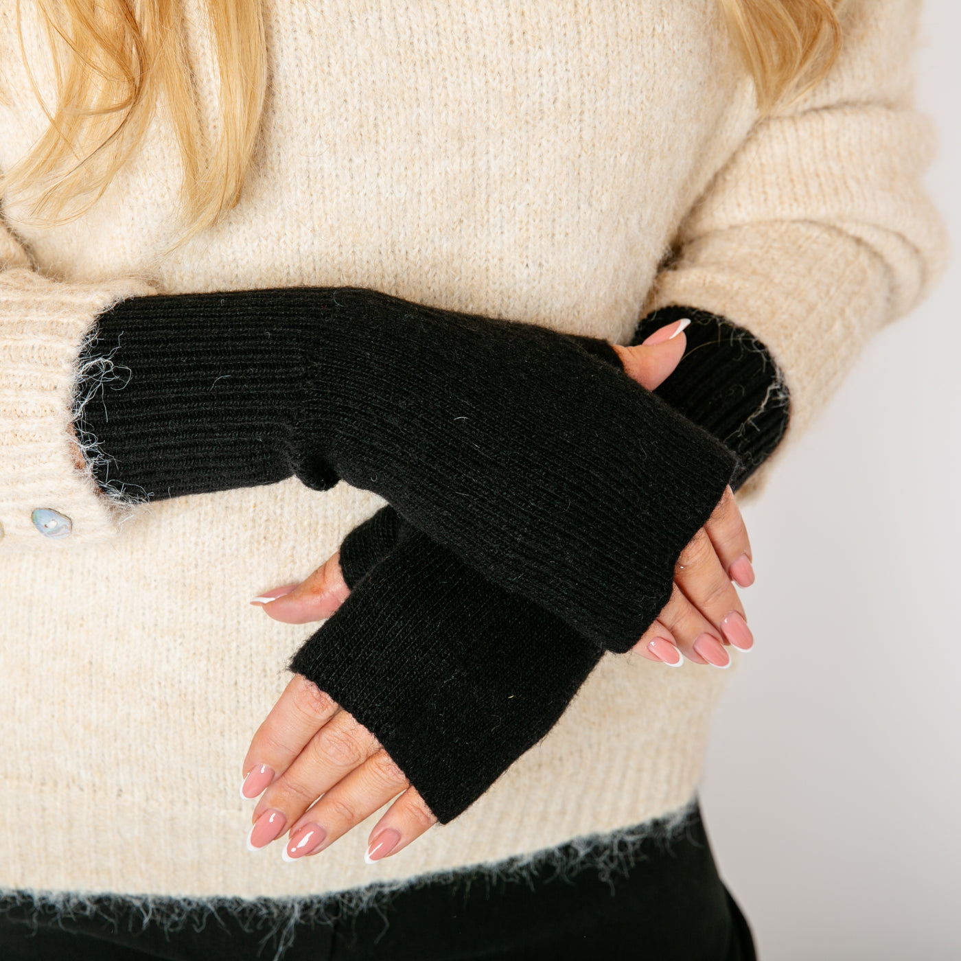 The black Freya Fingerless Gloves made from a soft, stretchy, ribbed material