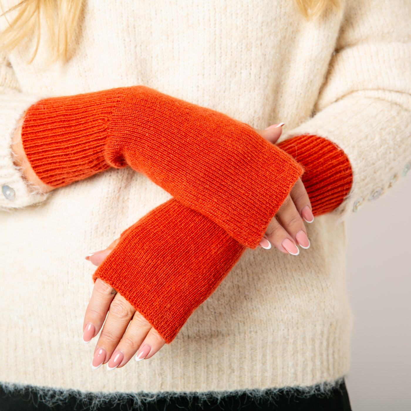 The cinamon orange Freya Fingerless Gloves made from a soft, stretchy, ribbed material