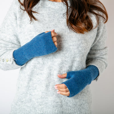 The denim blue Freya Fingerless Gloves made from a soft, stretchy, ribbed material