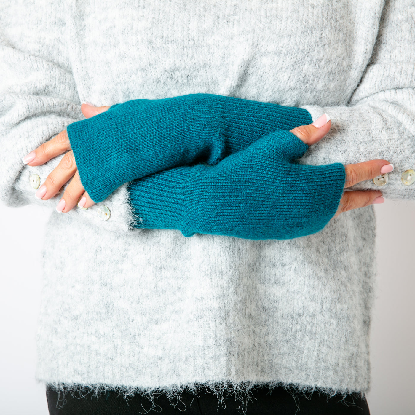 The teal blue Freya Fingerless Gloves made from a soft, stretchy, ribbed material