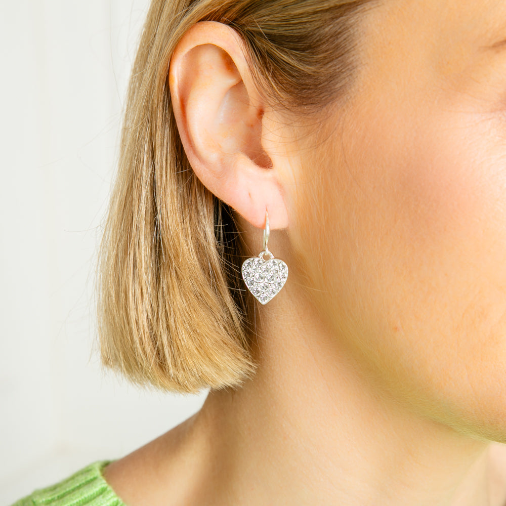 The Gigi Earrings in silver with a heart shape and sparkly gem diamanté's in the middle