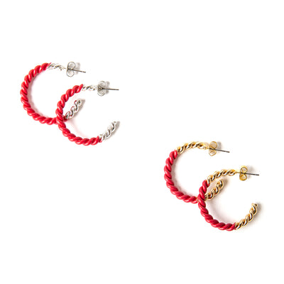 The Hannah Earrings in fuchsia pink red with silver and gold. Featuring a twist detail these hoops are a statement piece.