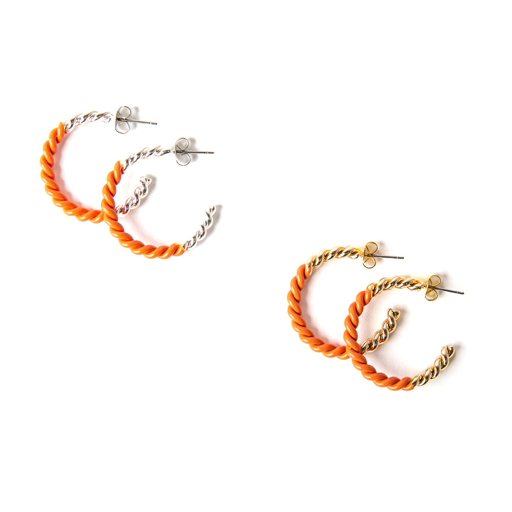 The Hannah Earrings in orange with silver and gold. Featuring a twist detail these hoops are a statement piece.