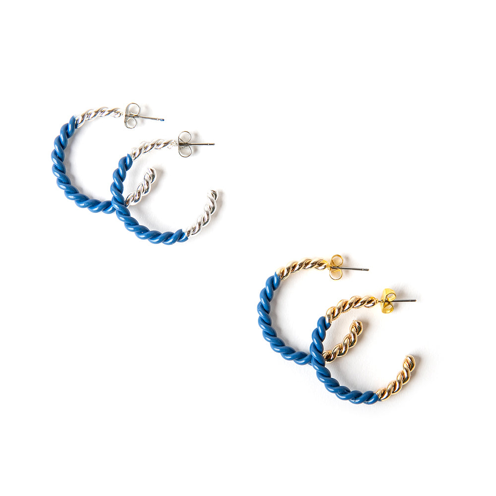 The Hannah Earrings in royal blue with silver and gold. Featuring a twist detail these hoops are a statement piece.