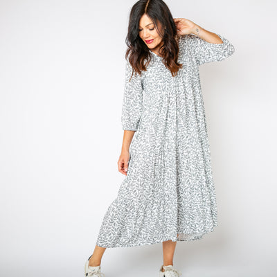 The white Hazel Patterned 3/4 Sleeve Dress with a v neckline and pockets on either side of the hip