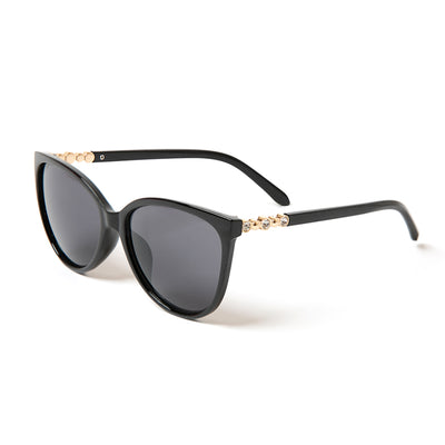 The Hazel Sunglasses with thin black plastic frames featuring gem detailing on either side