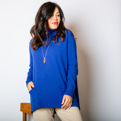 The royal blue High Neck Two Pocket Jumper with long sleeves that have ribbed detail on the cuffs