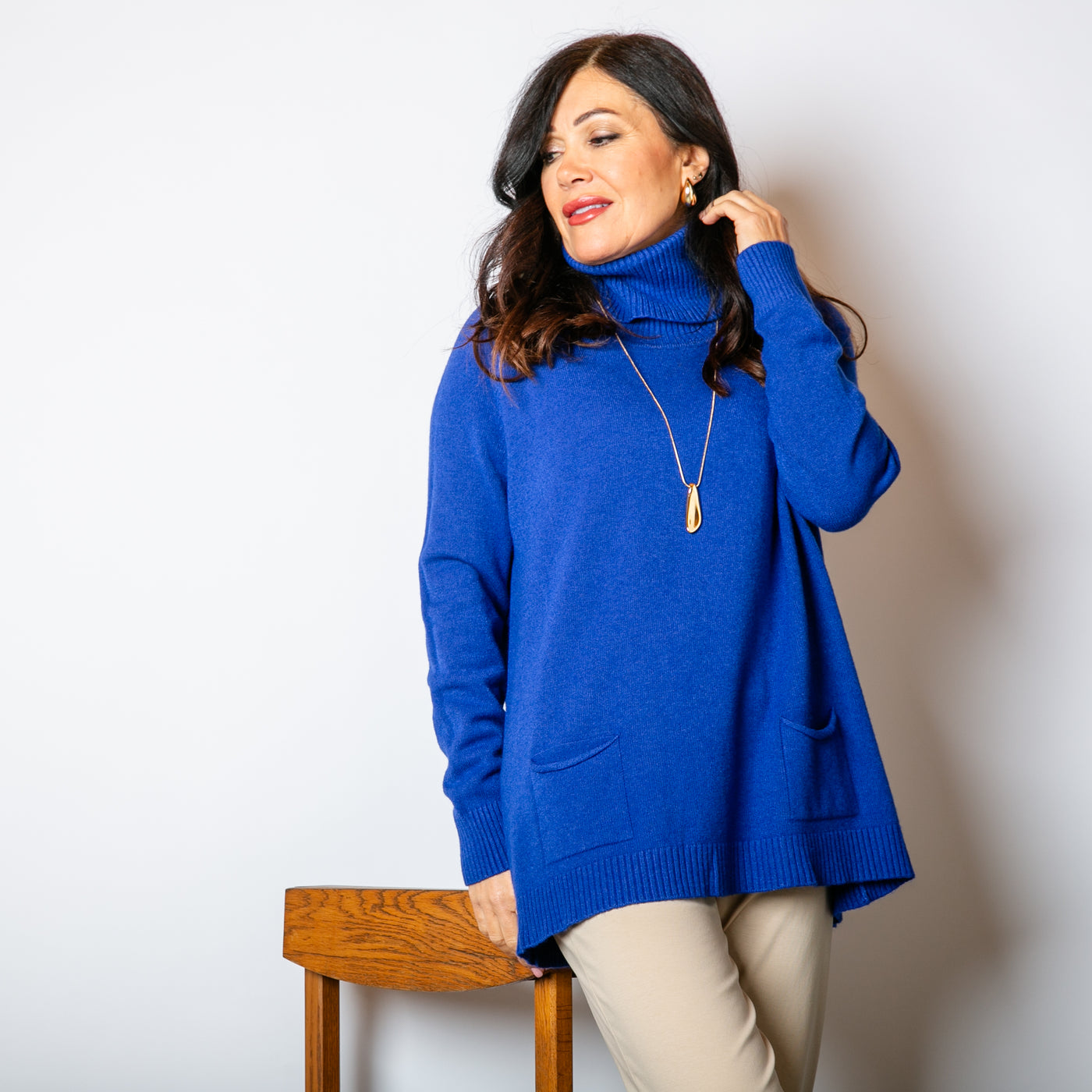 The royal blue High Neck Two Pocket Jumper with a high neckline that can be rolled to desired fit 