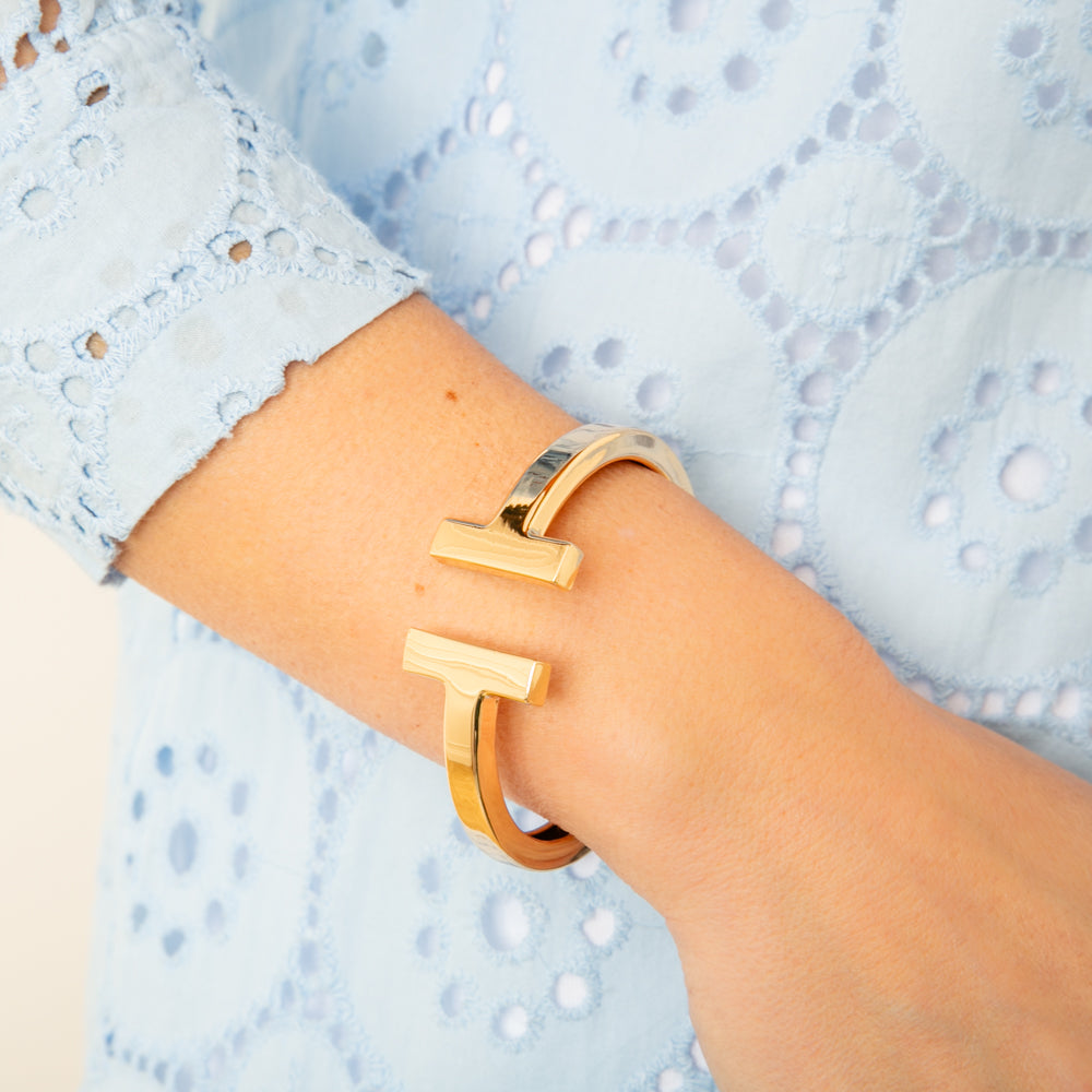 The gold Honey Cuff Bangle which makes a great accessory for dressing up an outfit