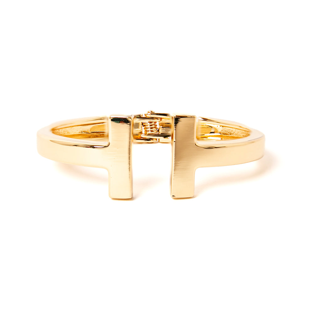 The gold Honey Cuff Bangle with T shaped ends and a hinge fastening for easy wear