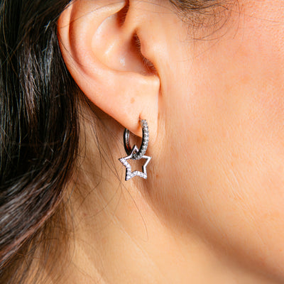 The Hoop Earrings in silver made up of a hoop ring with a sparkly star pendant hanging off it