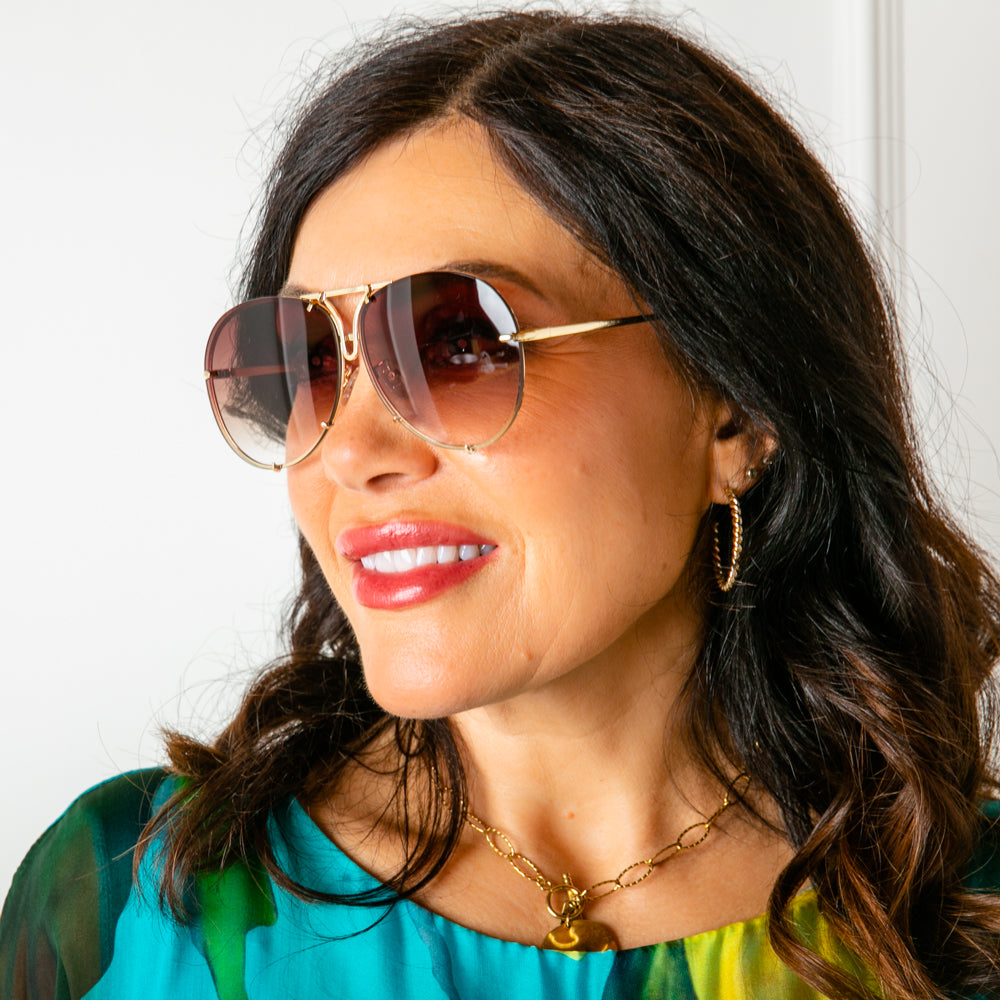 The Imogen Sunglasses featuring an oversized gold aviator frame