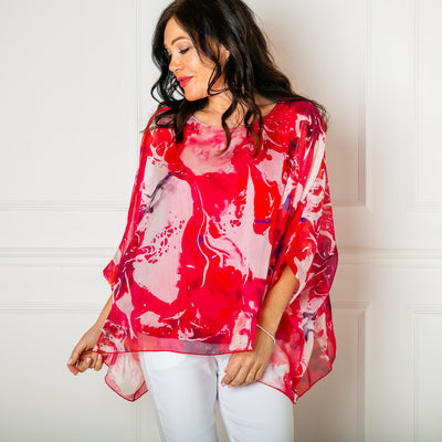 The fuchsia pink Ink Blot Blouse with a round neckline and big dropped sleeves