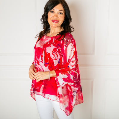 The fuchsia pink Ink Blot Blouse made up of a lightweight silky material and a stretchy lining underneath