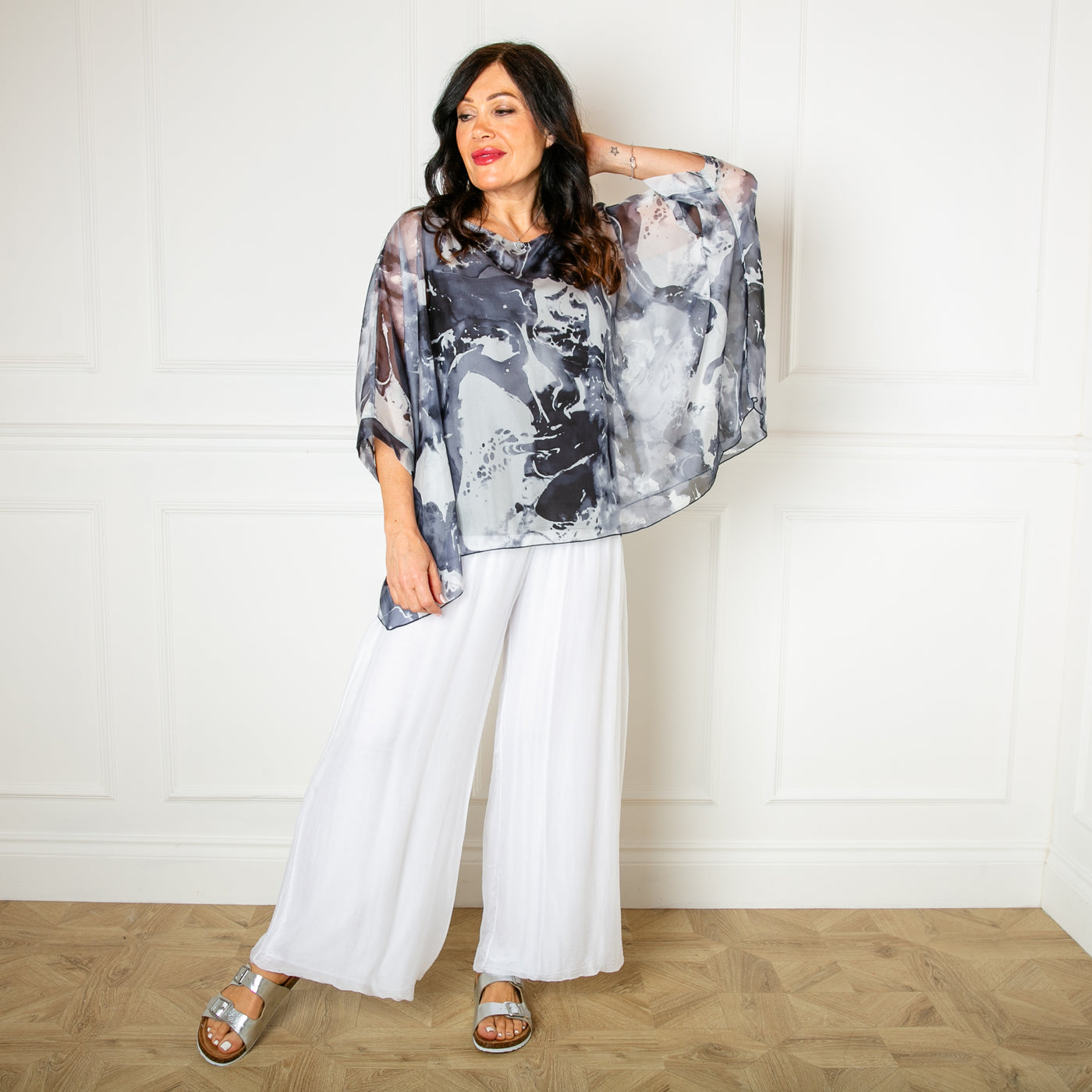 The charcoal grey Ink Blot Blouse made up of a lightweight silky material and a stretchy lining underneath