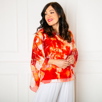 The orange Ink Blot Blouse with a round neckline and big dropped sleeves
