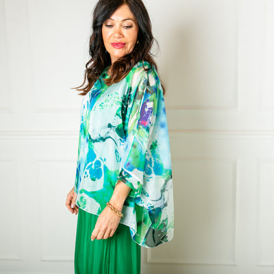 The turquoise blue green Ink Blot Blouse made up of a lightweight silky material and a stretchy lining underneath