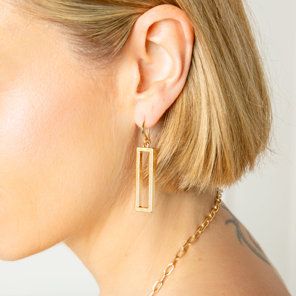 The Iona Earrings in gold, sleek and elegant, perfect for day or night time wear.