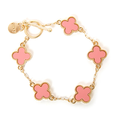 The pink Ivy Bracelet featuring four leaf clover shaped pendants on a wide link chain