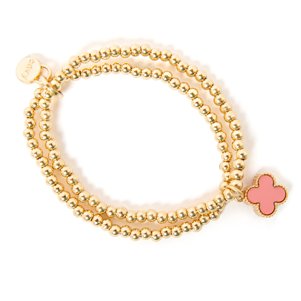 The pink Ivy Charm Bracelet made up of two gold beaded elasticated bands joined together with a charm