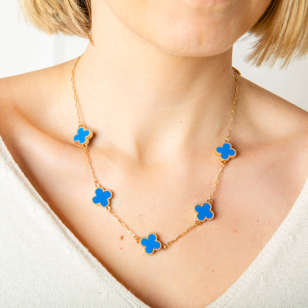 The blue Ivy Short Necklace with coloured clover shaped pendants with gold plating around the edges