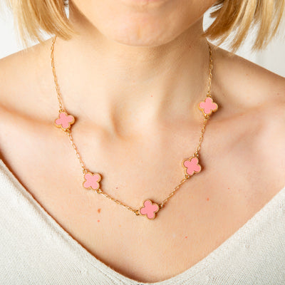 The pink Ivy Short Necklace with coloured clover shaped pendants with gold plating around the edges