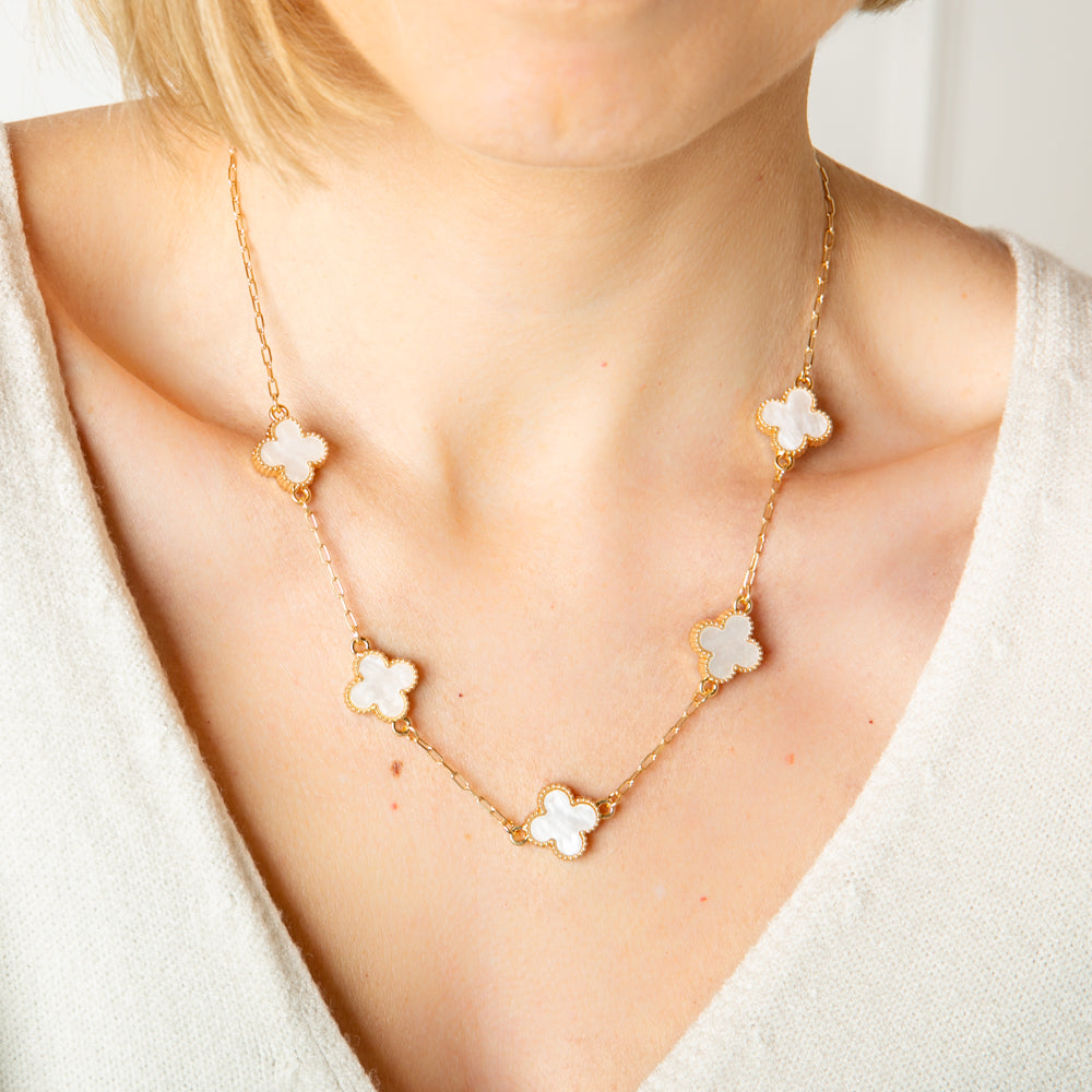 The white Ivy Short Necklace with coloured clover shaped pendants with gold plating around the edges