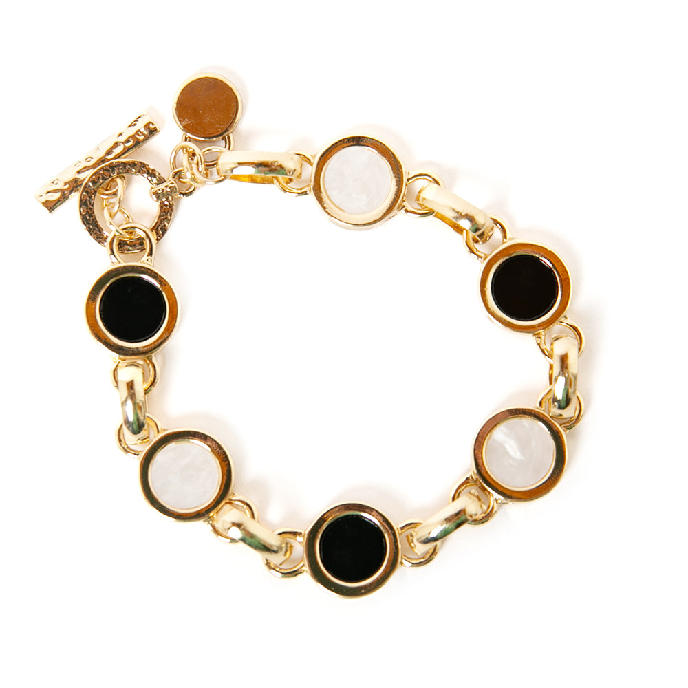 Jasmine Bracelet in gold with a chain link design and black and white disc pendants