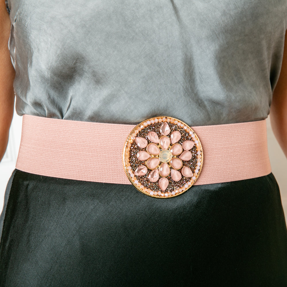 The Jules belt in dusky pink with a wide band of elastic and a metal clasp for fastening