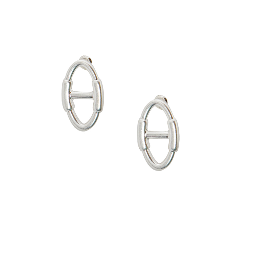 The Juno Earrings in silver which consist of an oval shaped stud with a bar across the middle and fasten behind the ear with a disc back