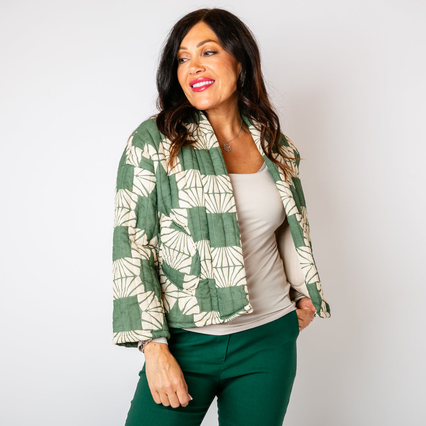 The forest green Kimono Pattern Quilted Jacket with pockets on either side of the hips