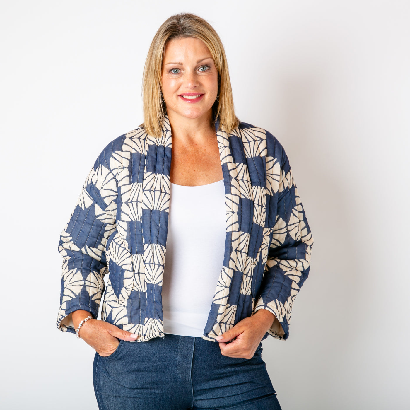 The navy blue Kimono Pattern Quilted Jacket with long sleeves and an open front