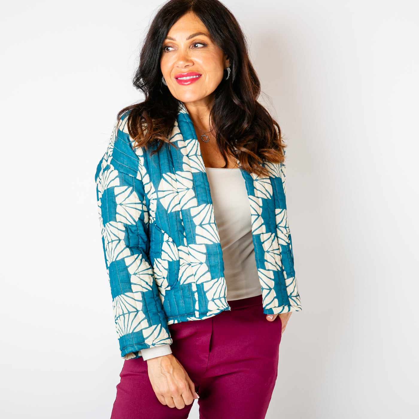 The teal blue Kimono Pattern Quilted Jacket with long sleeves and an open front