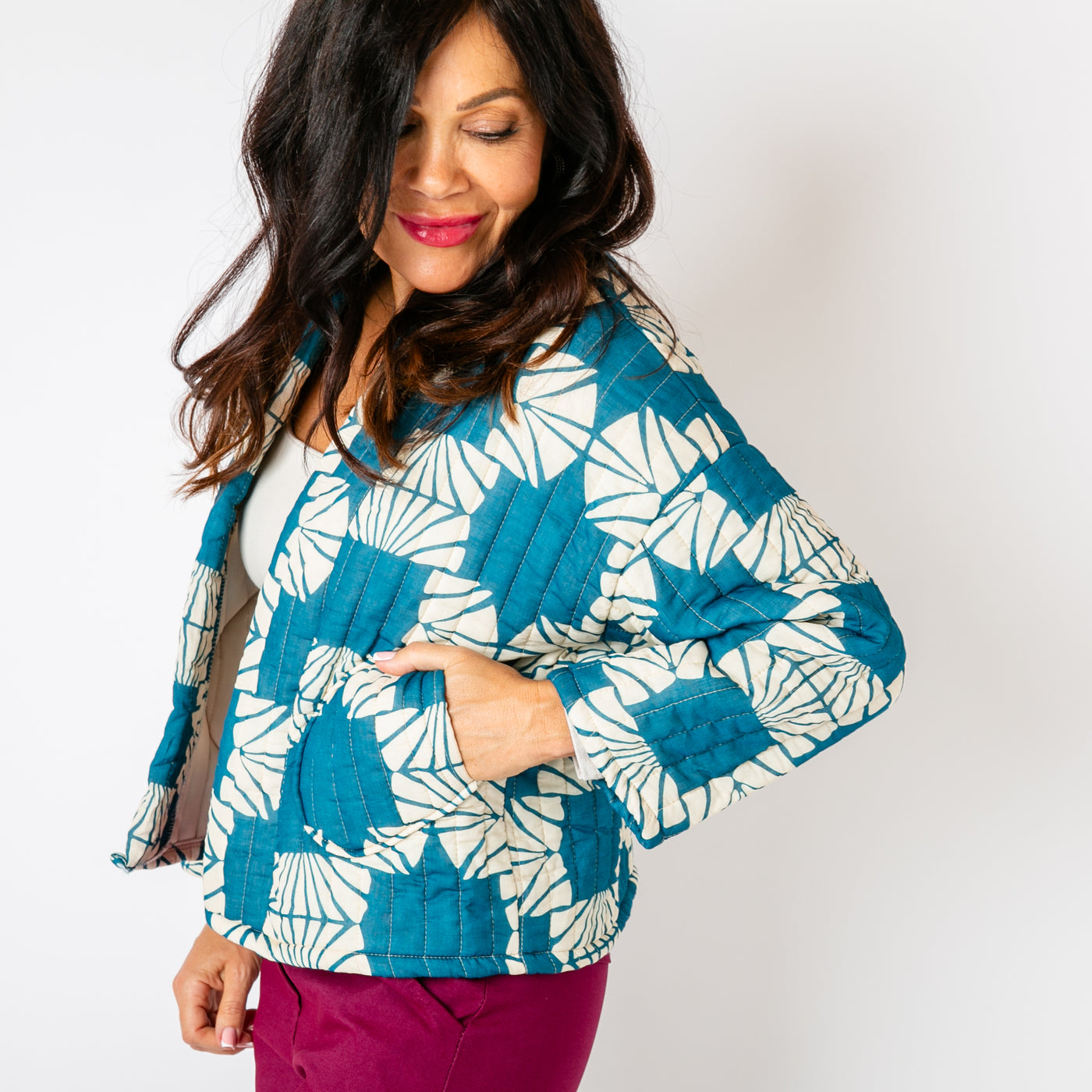 The teal blue Kimono Pattern Quilted Jacket with pockets on either side of the hips