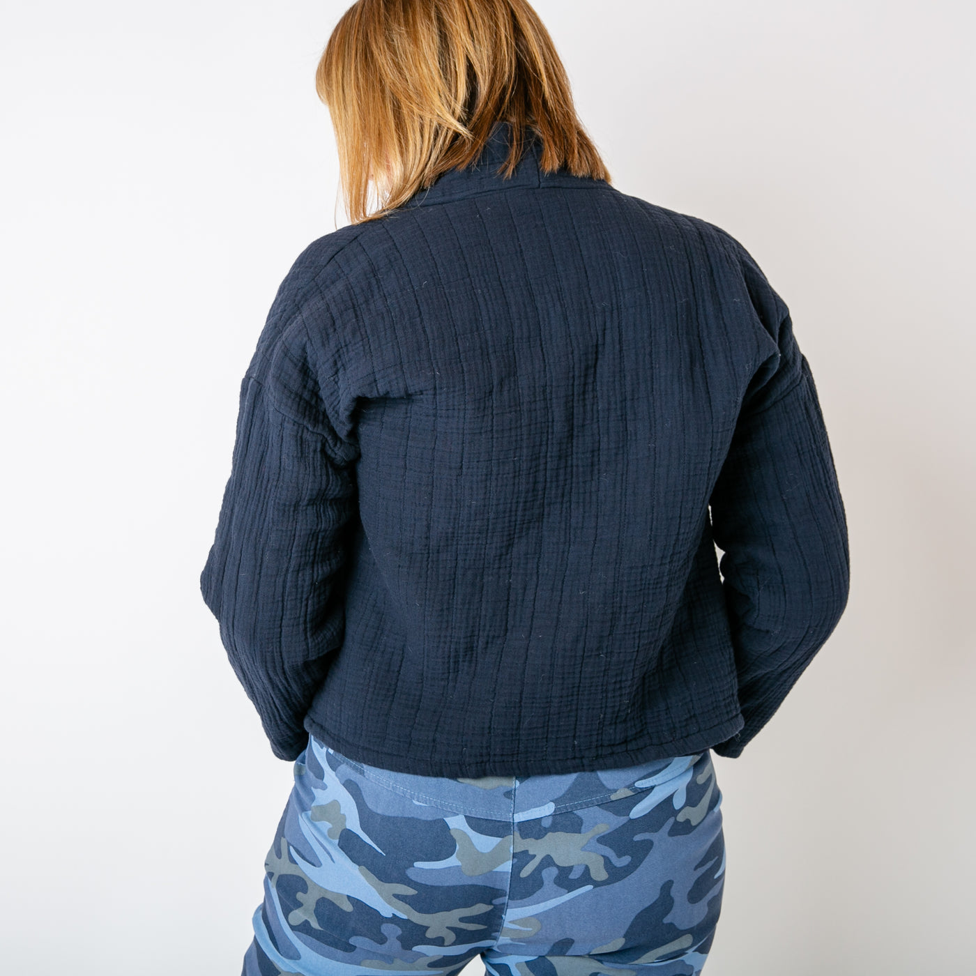 The navy blue Kimono Quilted Jacket with pockets on either side of the waist