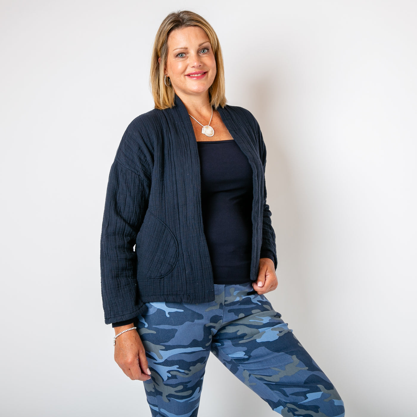 The navy blue Kimono Quilted Jacket with long sleeves and an open front