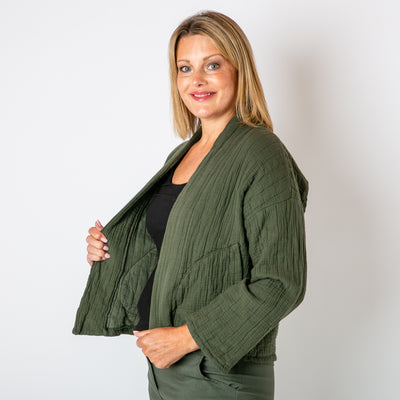 The khaki green Kimono Quilted Jacket with pockets on either side on either side of the waist