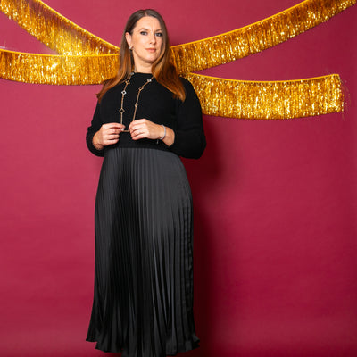 The black Knit And Satin Jumper Dress with long sleeves and a round neckline